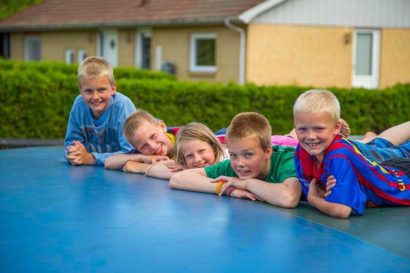 Børn ligger på hoppepude